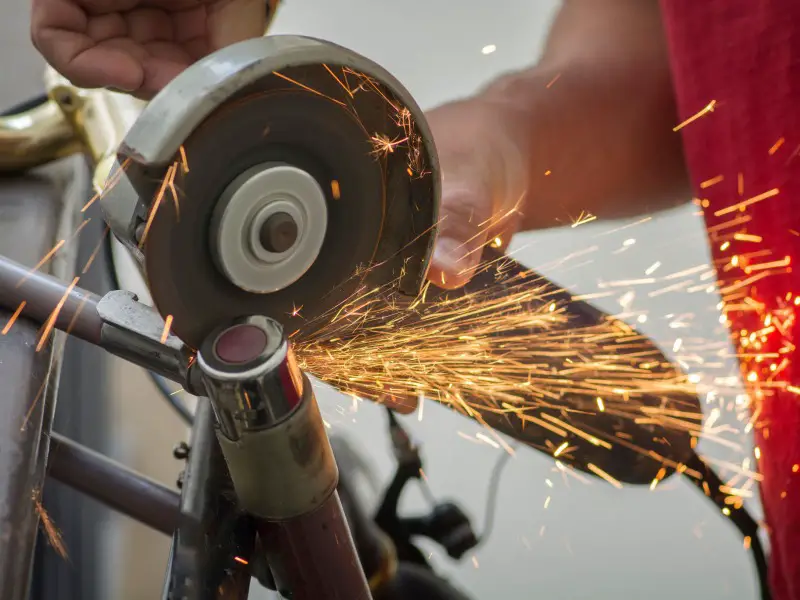 bike lock being cut with and angle grinder